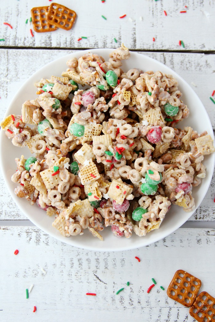 Easy Reindeer Chow - A delicious snack mix filled with pretzels, peanuts, Cheerios, Chex and M&Ms covered in white chocolate. Great for snacking and gift giving!