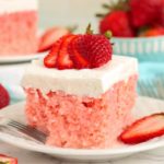 Piece of strawberry cake garnished with fresh strawberries
