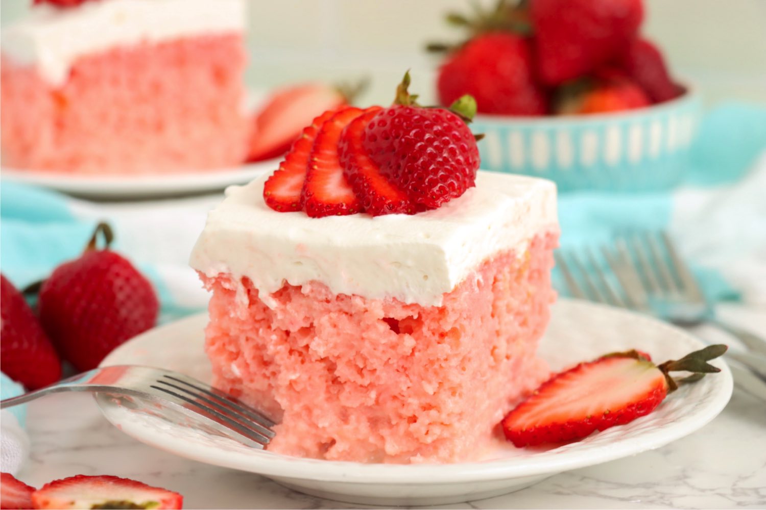 Piece of strawberry cake garnished with fresh strawberries