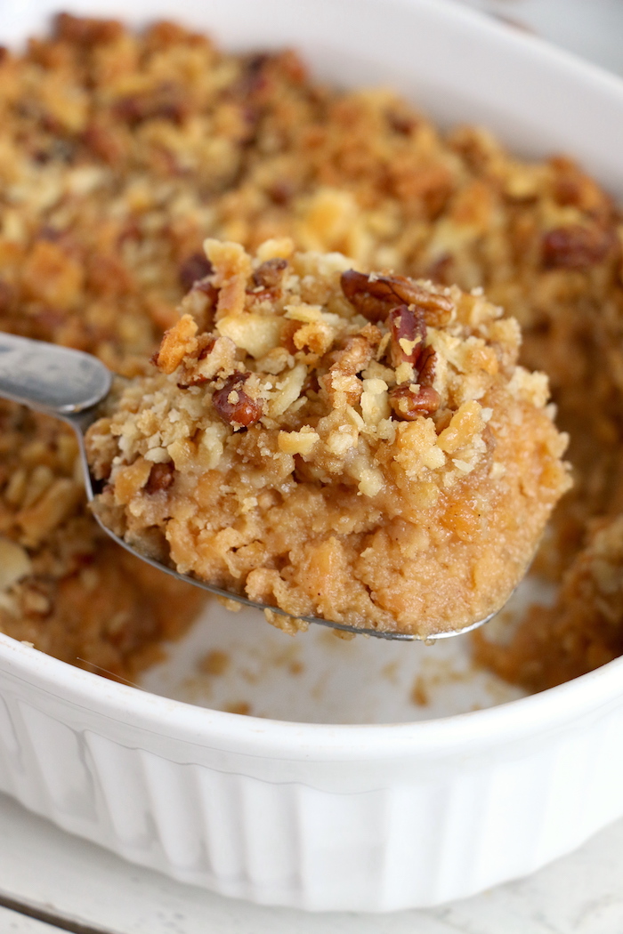 Easy Sweet Potato Casserole - An easy and delicious casserole that comes together with no scrubbing, boiling or baking the sweet potatoes! Topped with a sweet, salty and crunchy streusel, your guests will devour this simple and tasty side dish!