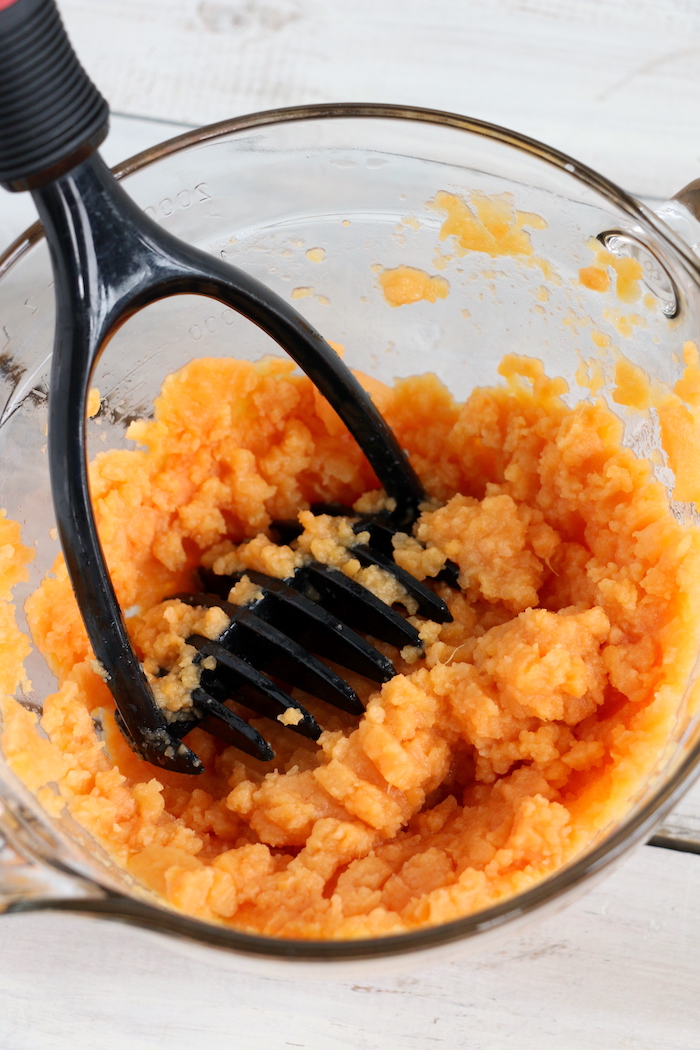 Easy Sweet Potato Casserole - An easy and delicious casserole that comes together with no scrubbing, boiling or baking the sweet potatoes! Topped with a sweet, salty and crunchy streusel, your guests will devour this simple and tasty side dish!