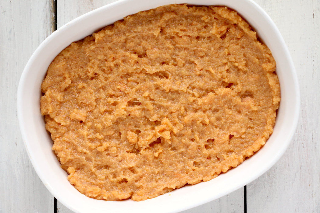 Easy Sweet Potato Casserole - An easy and delicious casserole that comes together with no scrubbing, boiling or baking the sweet potatoes! Topped with a sweet, salty and crunchy streusel, your guests will devour this simple and tasty side dish!