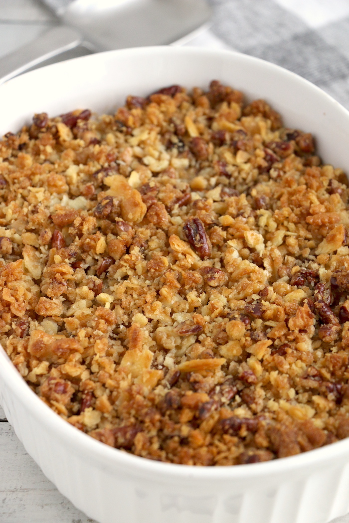 Easy Sweet Potato Casserole - An easy and delicious casserole that comes together with no scrubbing, boiling or baking the sweet potatoes! Topped with a sweet, salty and crunchy streusel, your guests will devour this simple and tasty side dish!
