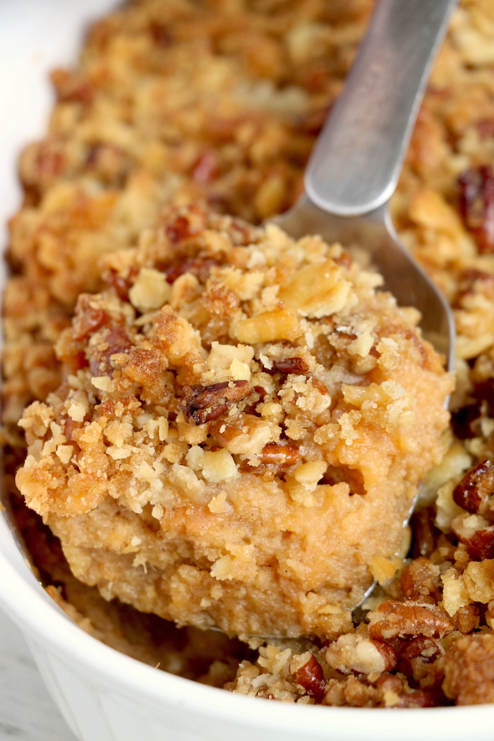 Easy Sweet Potato Casserole - An easy and delicious casserole that comes together with no scrubbing, boiling or baking the sweet potatoes! Topped with a sweet, salty and crunchy streusel, your guests will devour this simple and tasty side dish!
