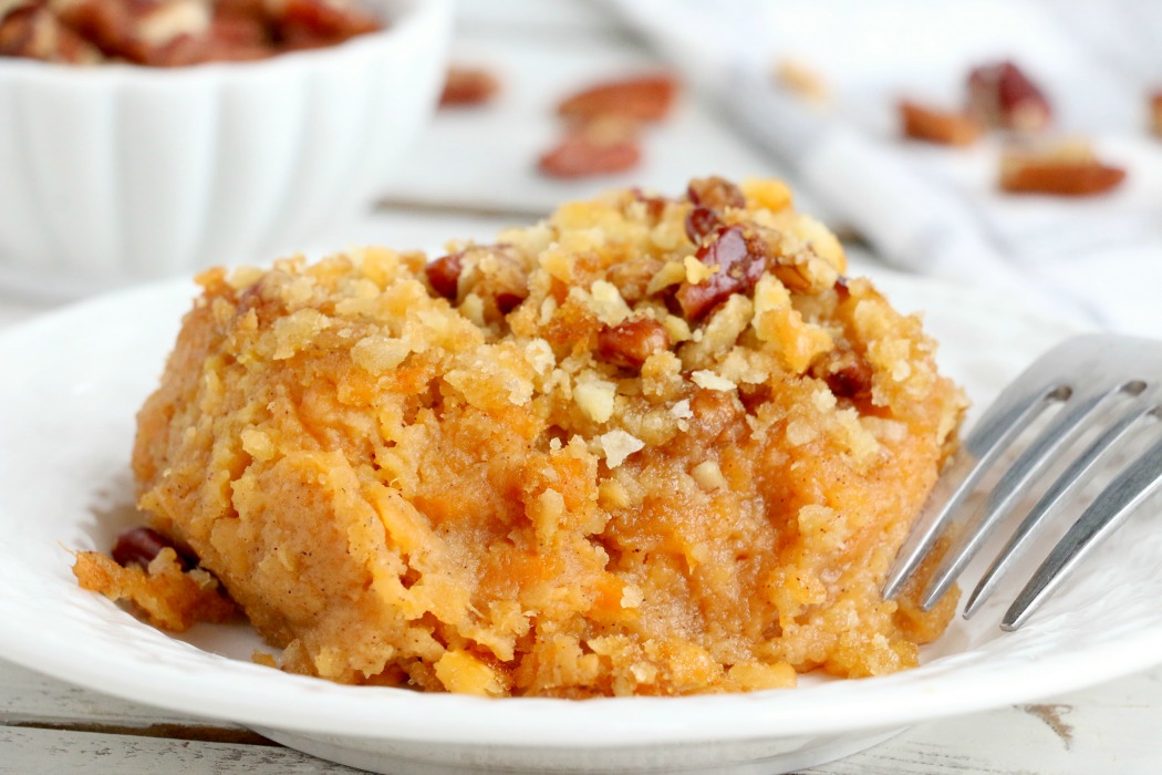 Easy Sweet Potato Casserole - An easy and delicious casserole that comes together with no scrubbing, boiling or baking the sweet potatoes! Topped with a sweet, salty and crunchy streusel, your guests will devour this simple and tasty side dish!