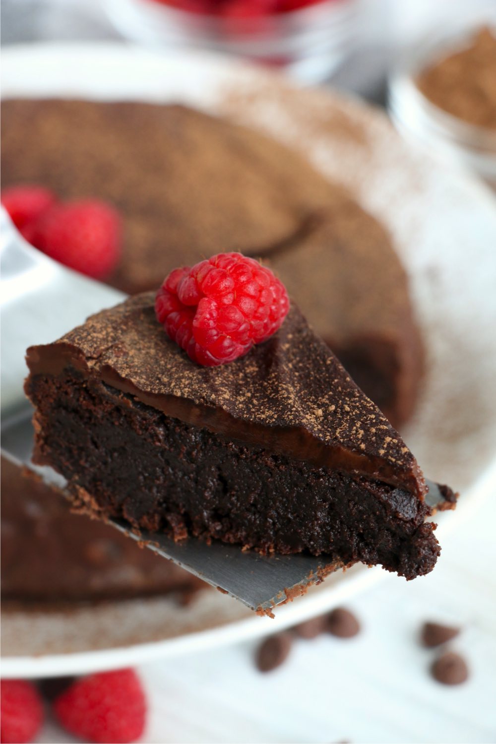piece of flourless chocolate cake on cake server