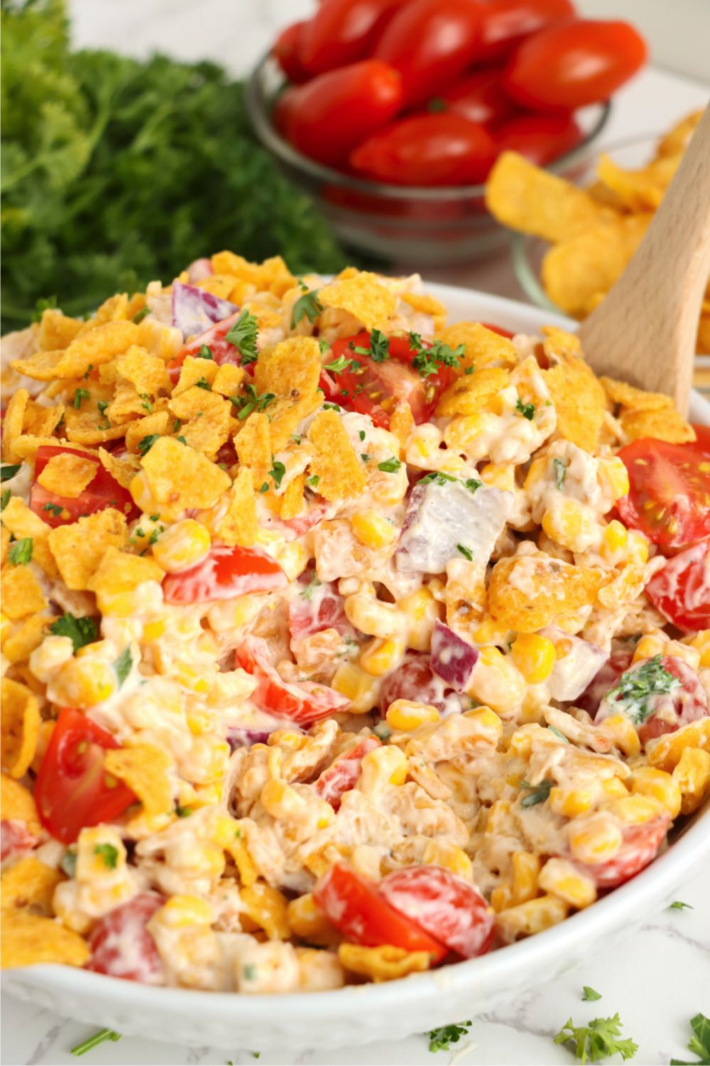 spoon in a bowl full of corn salad