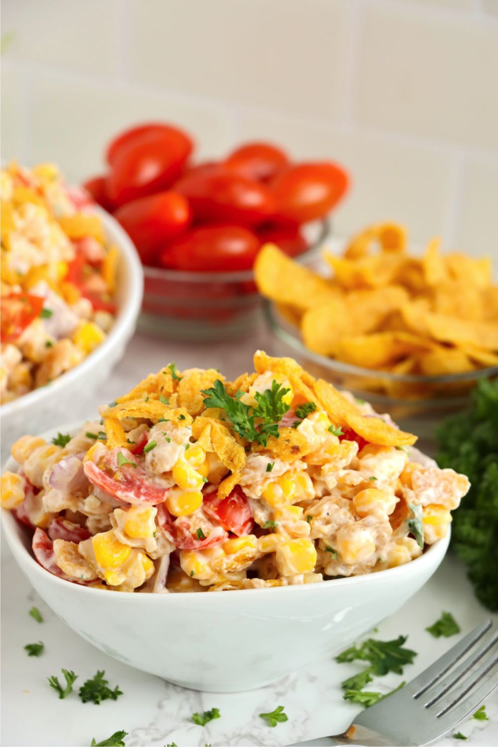 white bowl filled with Frito corn salad