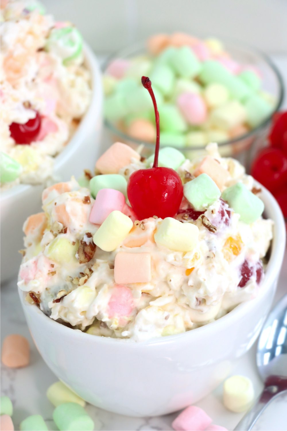 stemmed cherry on top of a fruit salad