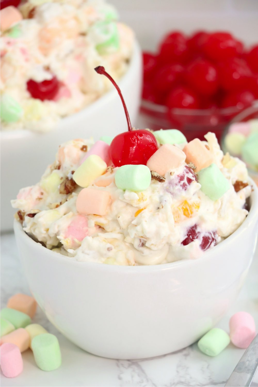 Fruit and whipped cream salad in a white bowl