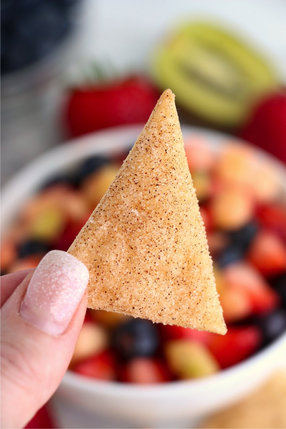 holding up a pie crust chip