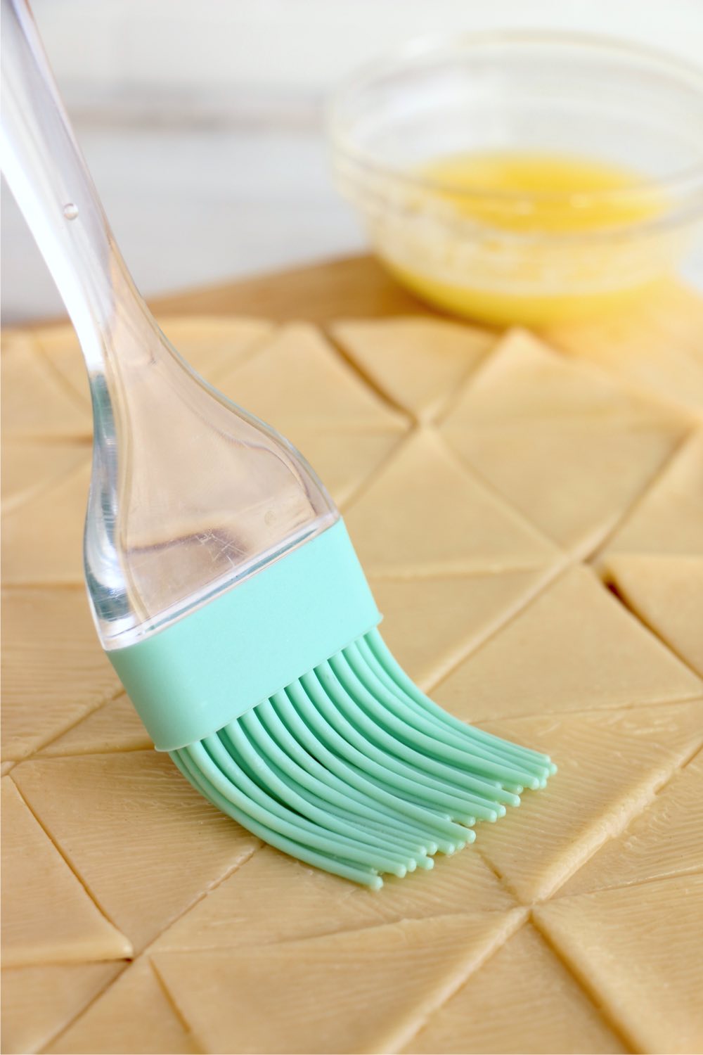 brushing pie crust dough with butter