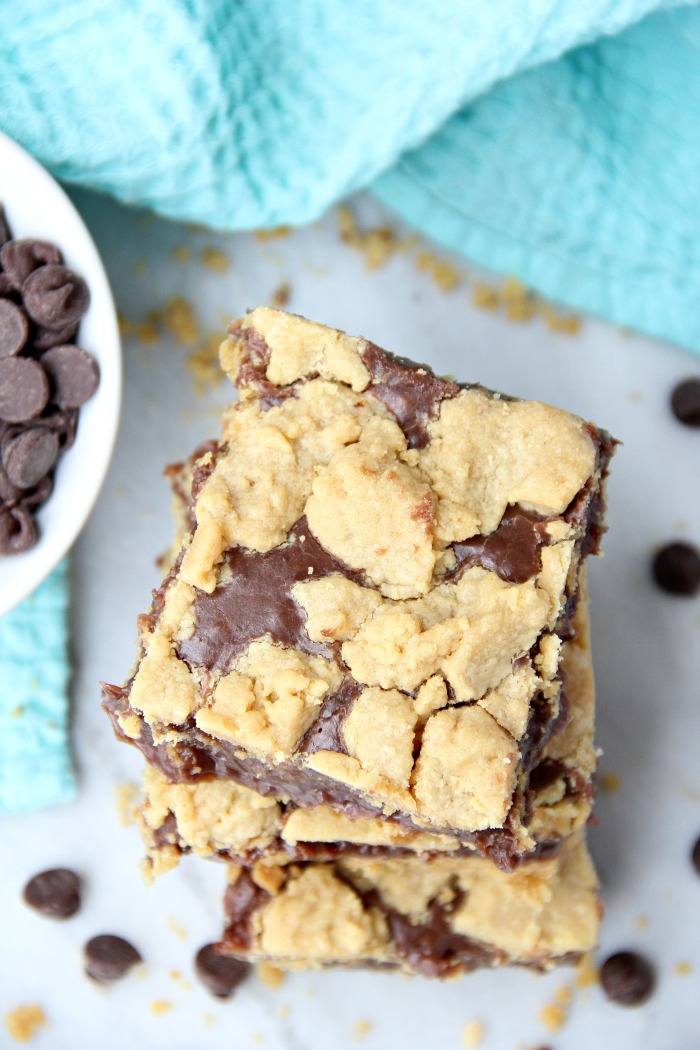 Fudge Crumble Bars - Fudge, peanut butter and coconut pecan frosting enveloped by a delicious yellow cake mix crust and crumble topping!