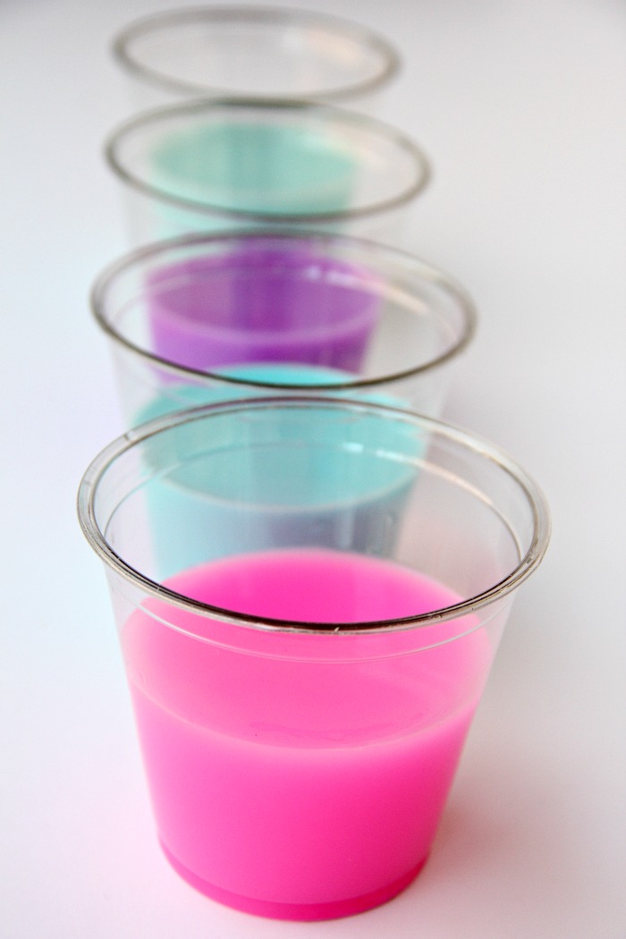 DIY Galaxy Jar -A gorgeous craft for kids, teens or even adults who love color and glitter! Simply layer cotton balls, acrylic paint, water and glitter shapes to create your own galaxy in a jar!