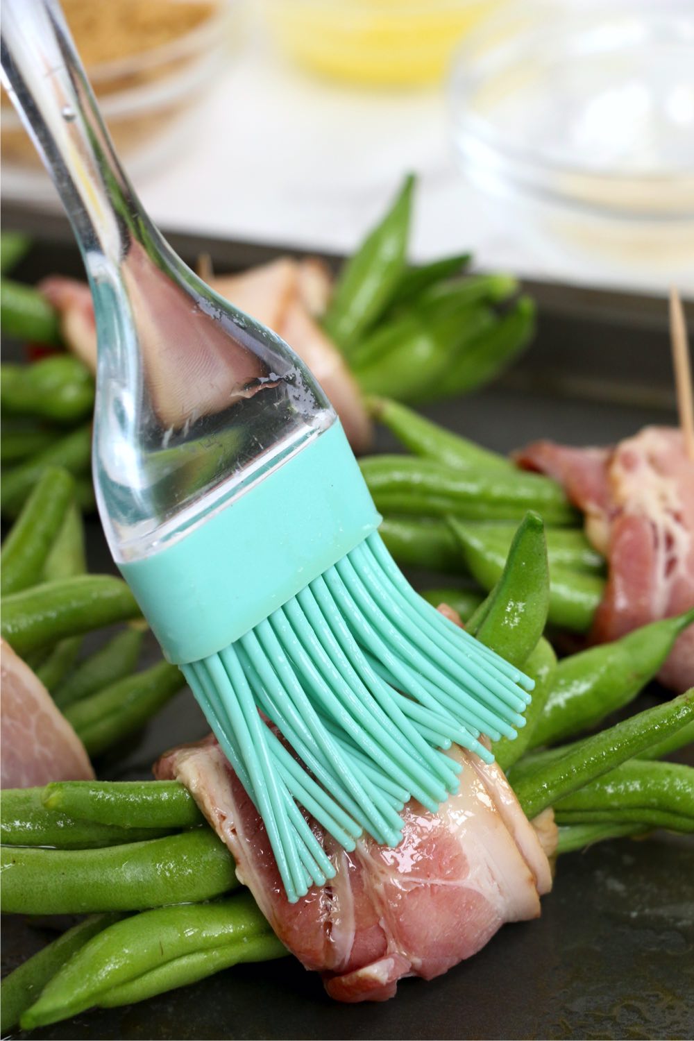 brushing green bean bundles with butter