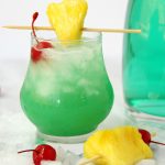 Green Hawaiian Cocktail - a beautiful and refreshing combination of vodka, coconut rum, blue curacao, pineapple juice and lemon-lime soda. It's the perfect drink for summer!