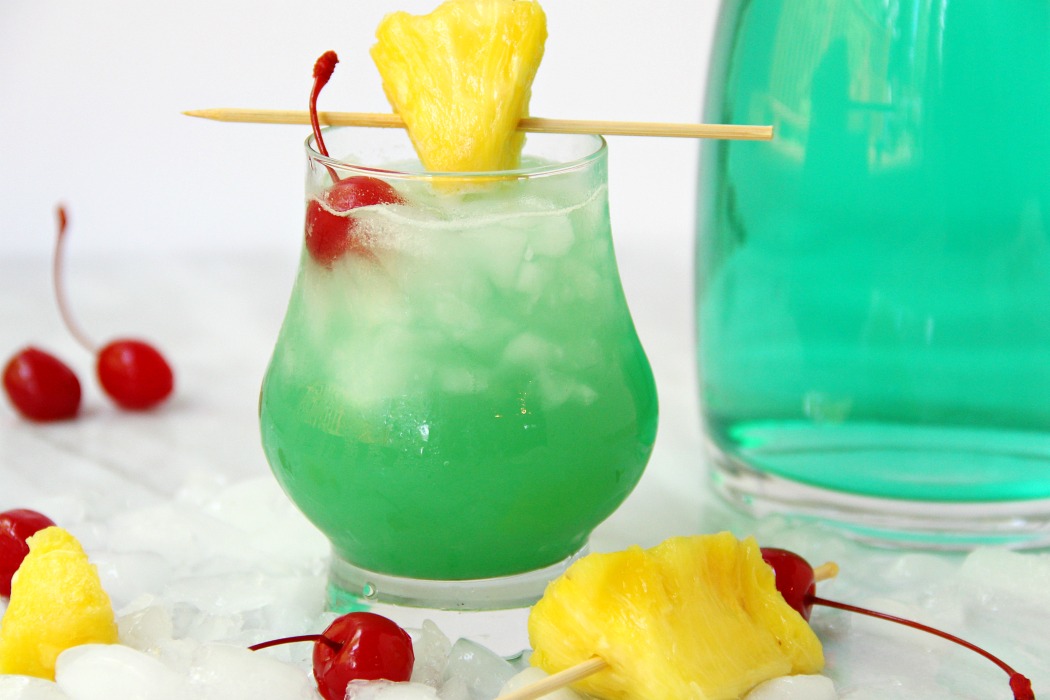 Green Hawaiian Cocktail - a beautiful and refreshing combination of vodka, coconut rum, blue curacao, pineapple juice and lemon-lime soda. It's the perfect drink for summer!