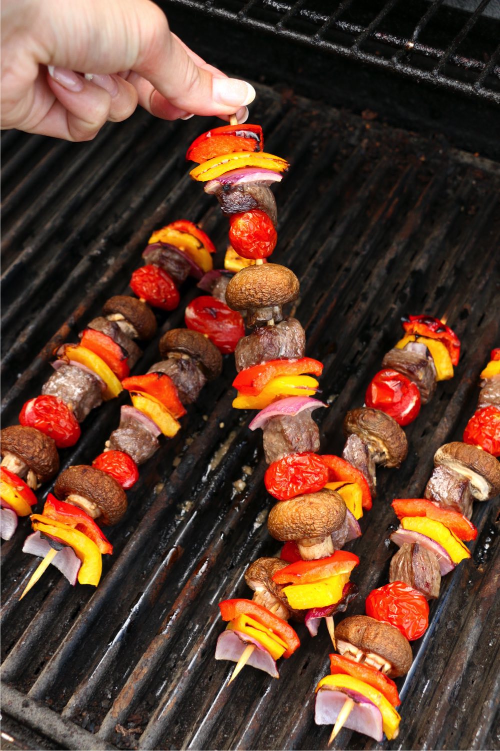 lifting kabob off of the grill