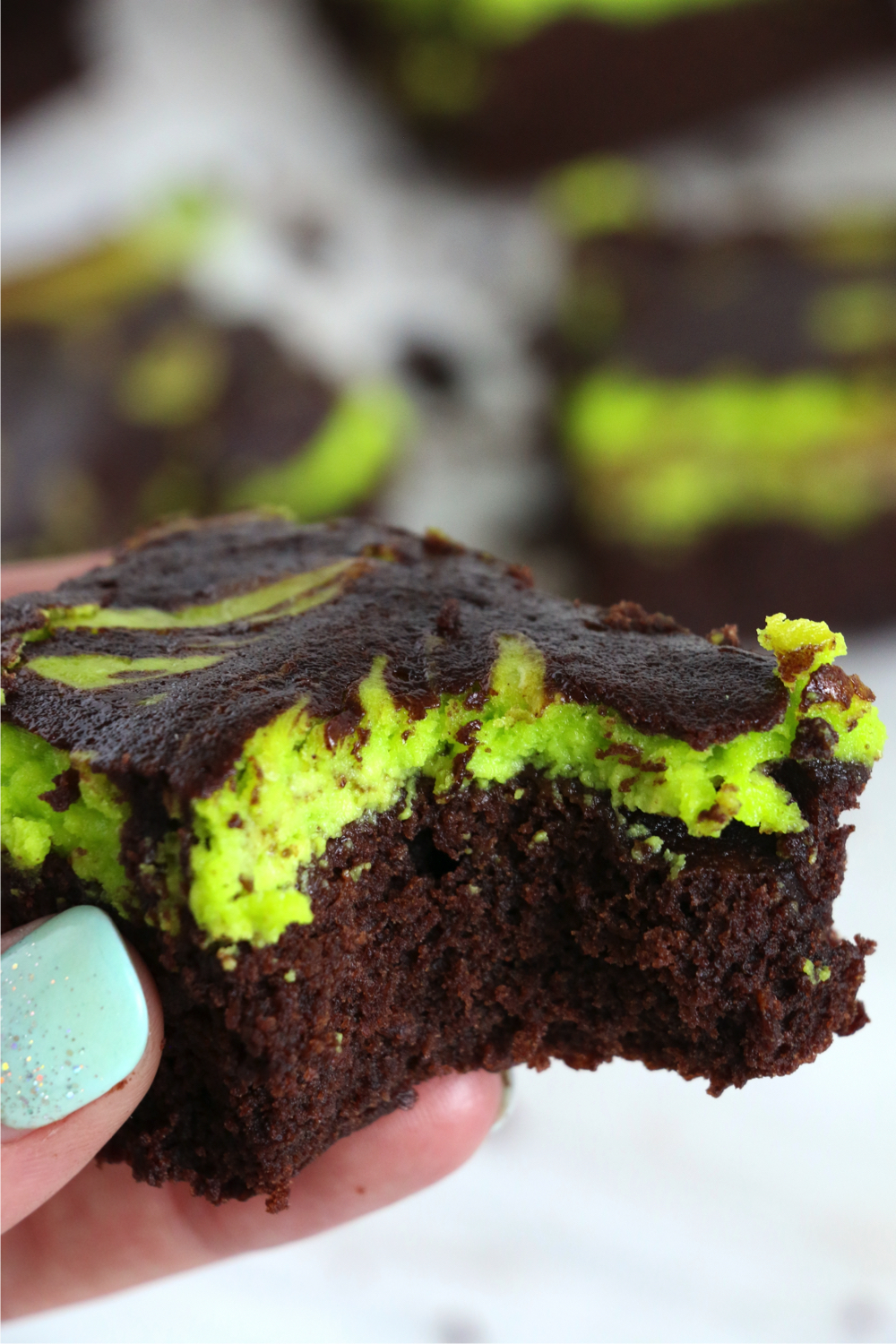 holding a brownie with a bite taken out