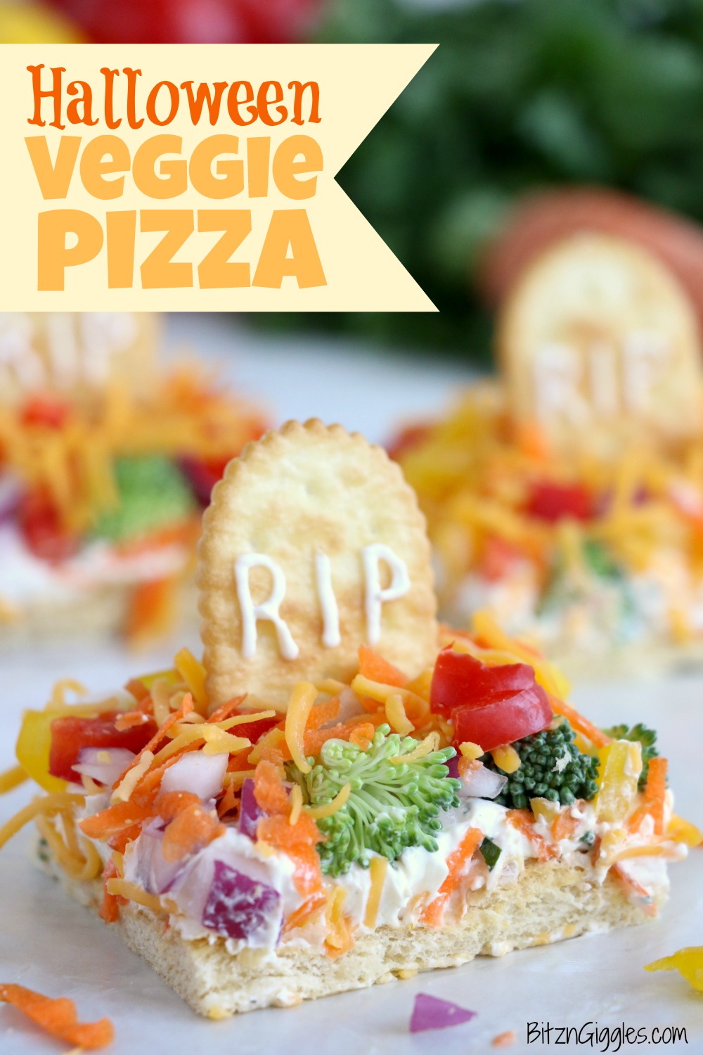 Halloween Veggie Pizza - A spooky themed graveyard pizza featuring a flavorful ranch cream cheese covered crust, topped with colorful veggies and "tombstone" crackers.