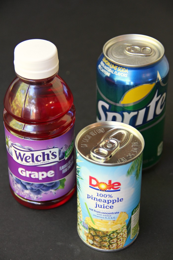 Spooky Halloween Punch - This Halloween punch is only three ingredients! When served in a nonpareil-rimmed glass, the color of the candy starts dripping eerily into the punch, creating fun black streaks and darkening the color of the drink!