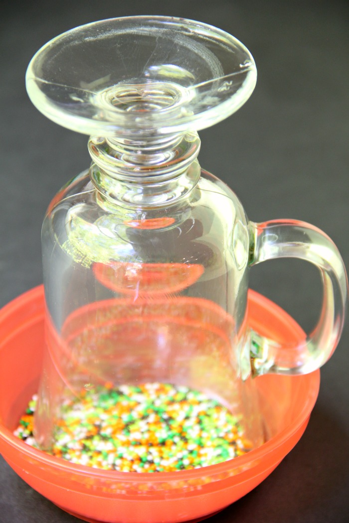 Spooky Halloween Punch - This Halloween punch is only three ingredients! When served in a nonpareil-rimmed glass, the color of the candy starts dripping eerily into the punch, creating fun black streaks and darkening the color of the drink!