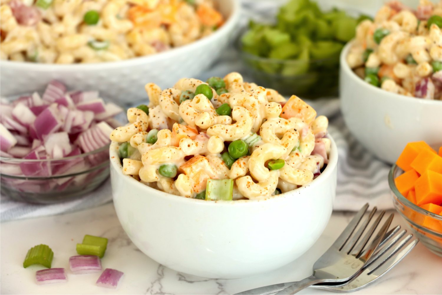 small bowl of macaroni salad with ham and peas