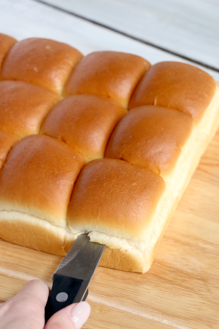 Ham and Cheese Sliders -Hawaiian rolls filled with ham, cheese, onions and a delicious mustard sauce, then brushed with butter. A great appetizer to feed a crowd!