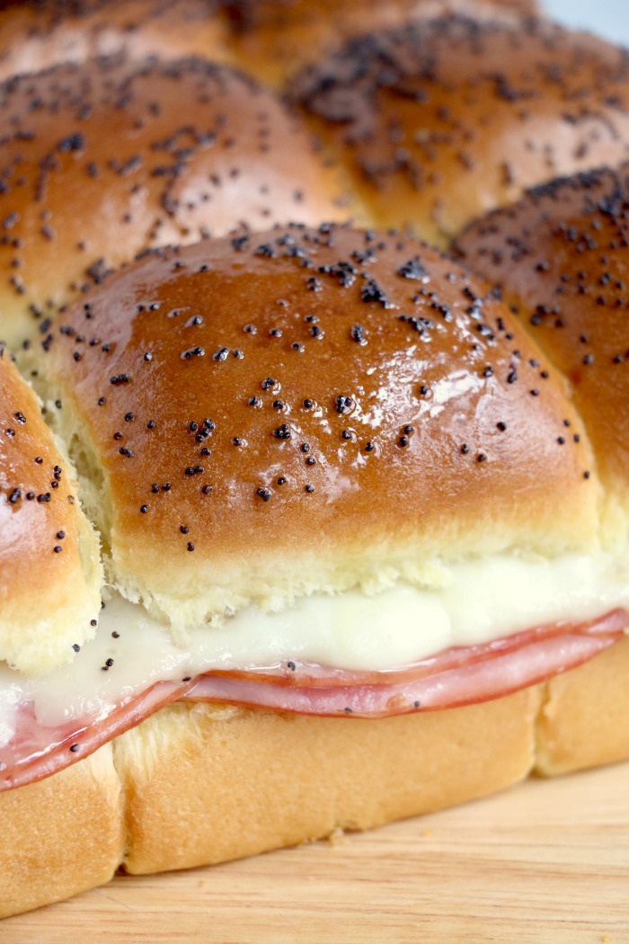 Ham and Cheese Sliders -Hawaiian rolls filled with ham, cheese, onions and a delicious mustard sauce, then brushed with butter. A great appetizer to feed a crowd!