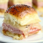 Ham and Cheese Sliders -Hawaiian rolls filled with ham, cheese, onions and a delicious mustard sauce, then brushed with butter. A great appetizer to feed a crowd!