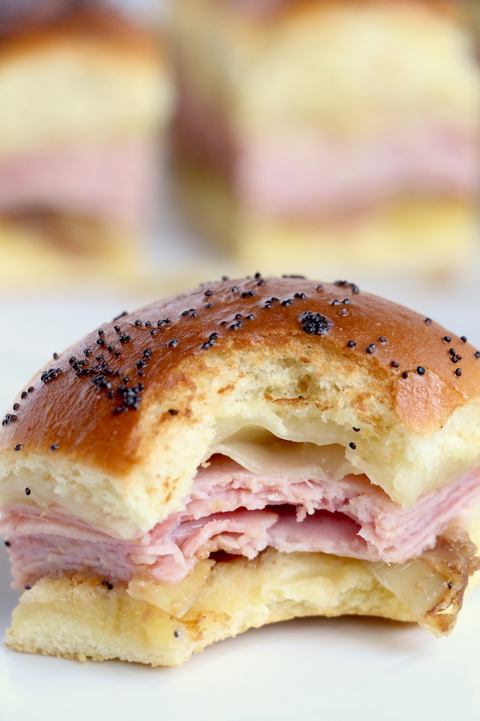 Ham and Cheese Sliders -Hawaiian rolls filled with ham, cheese, onions and a delicious mustard sauce, then brushed with butter. A great appetizer to feed a crowd!