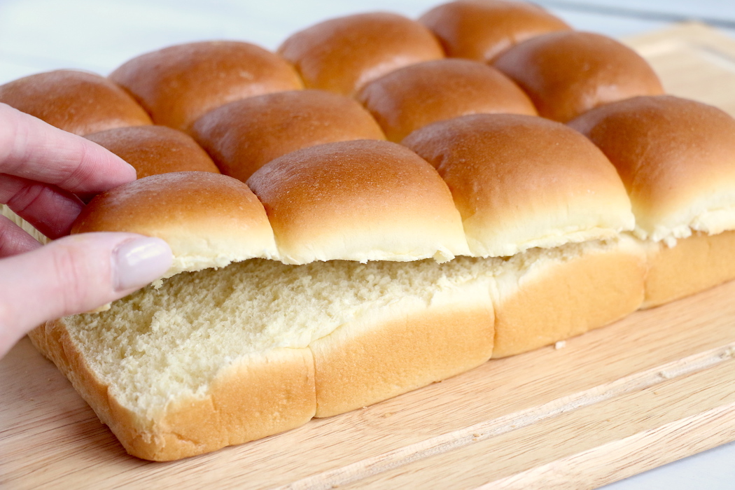 Ham and Cheese Sliders -Hawaiian rolls filled with ham, cheese, onions and a delicious mustard sauce, then brushed with butter. A great appetizer to feed a crowd!