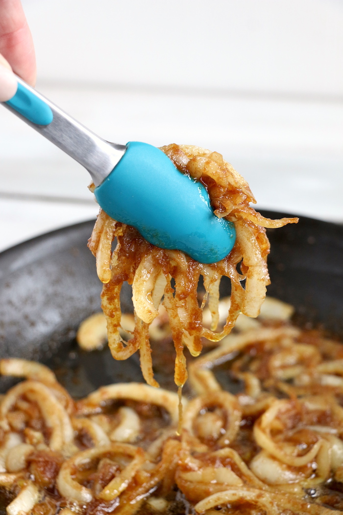 Ham and Cheese Sliders -Hawaiian rolls filled with ham, cheese, onions and a delicious mustard sauce, then brushed with butter. A great appetizer to feed a crowd!