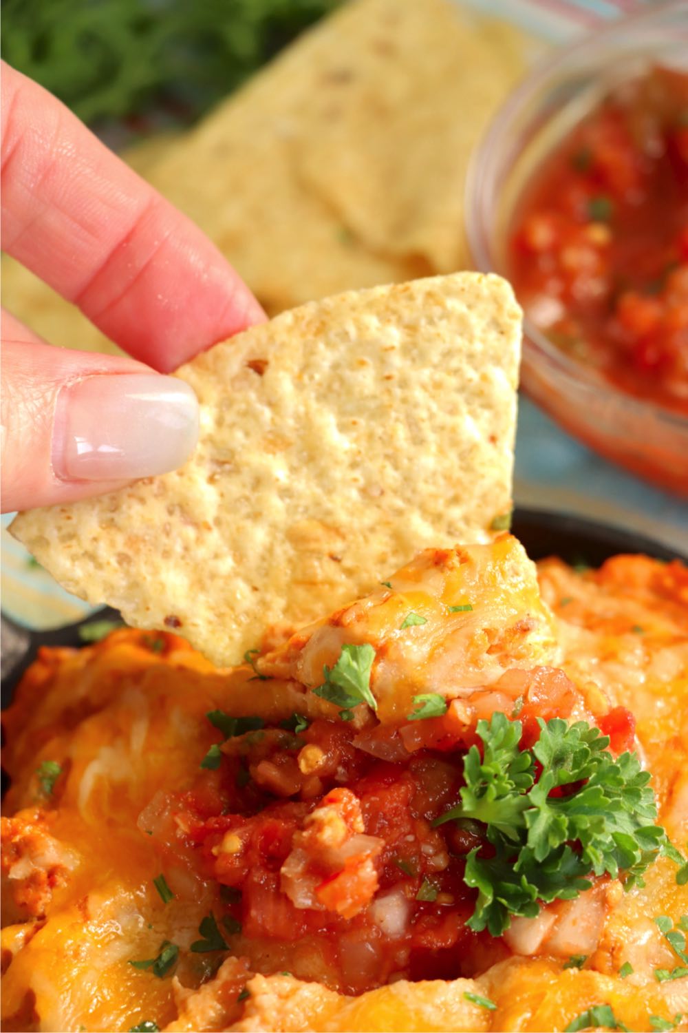 dipping a chip into homemade bean dip