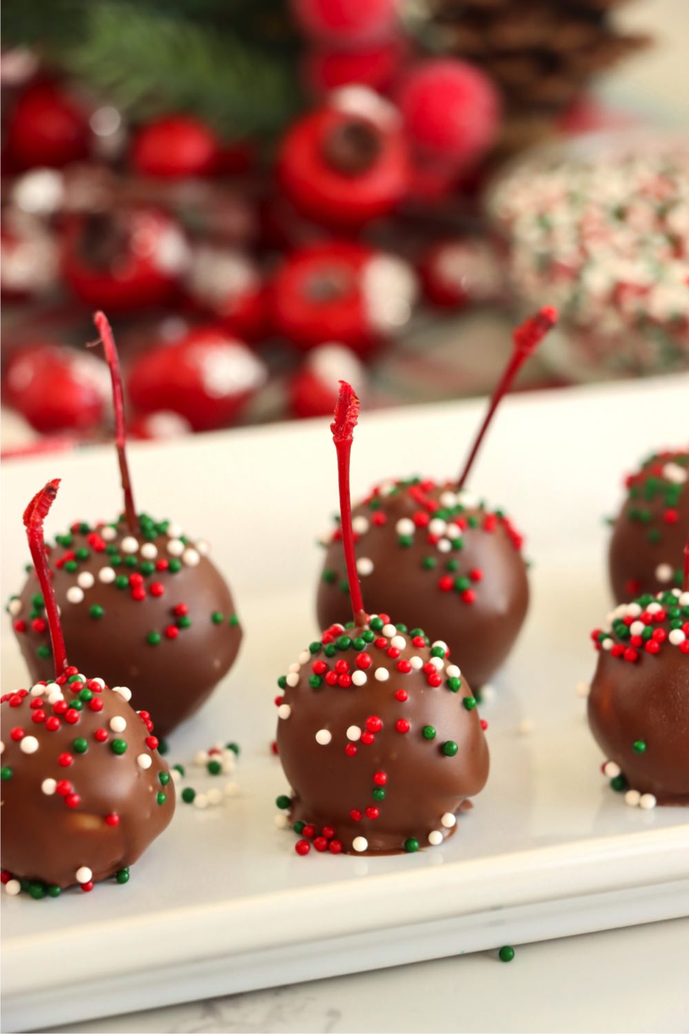 chocolate covered cherries on a white serving plate