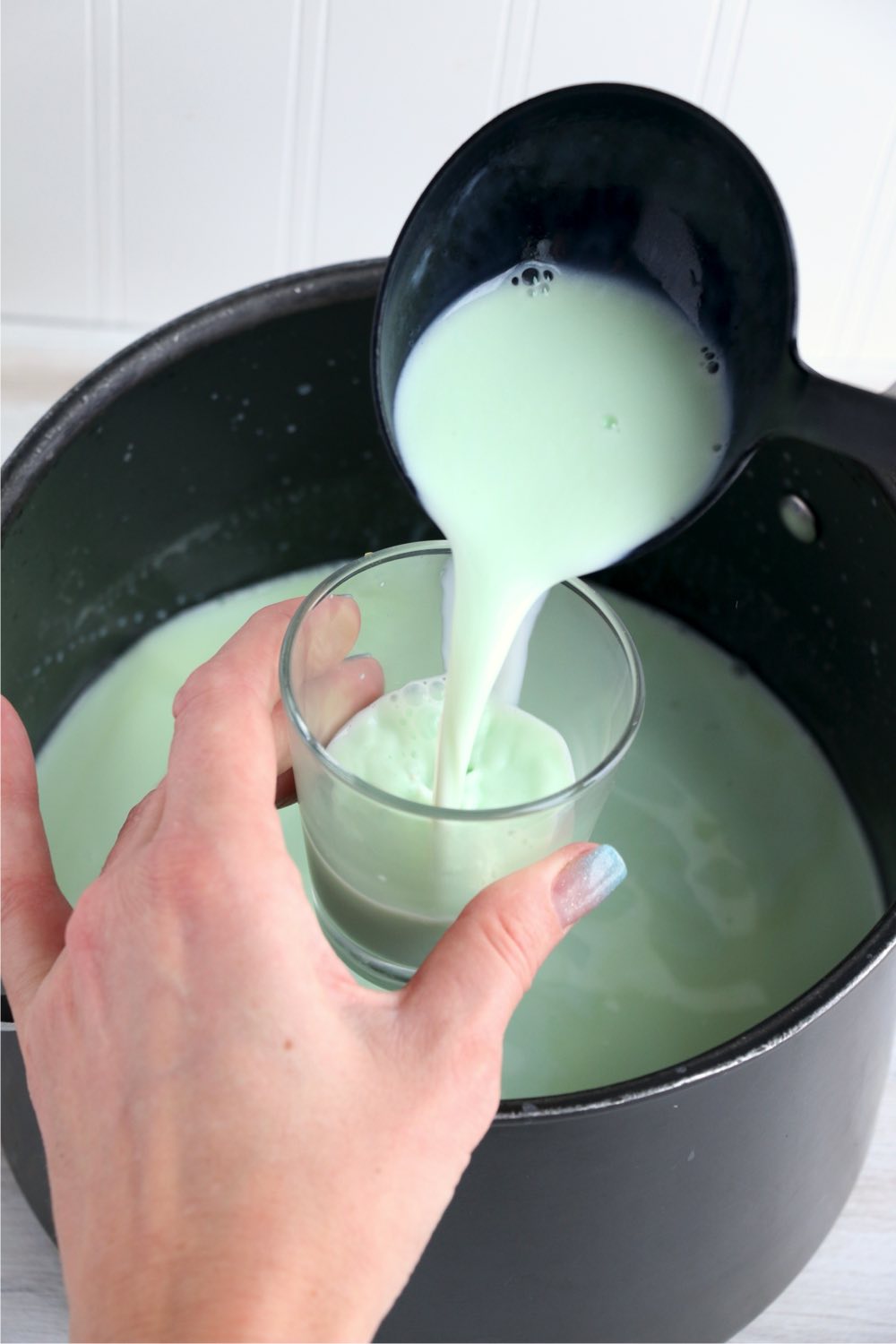 pouring green hot chocolate into a glass