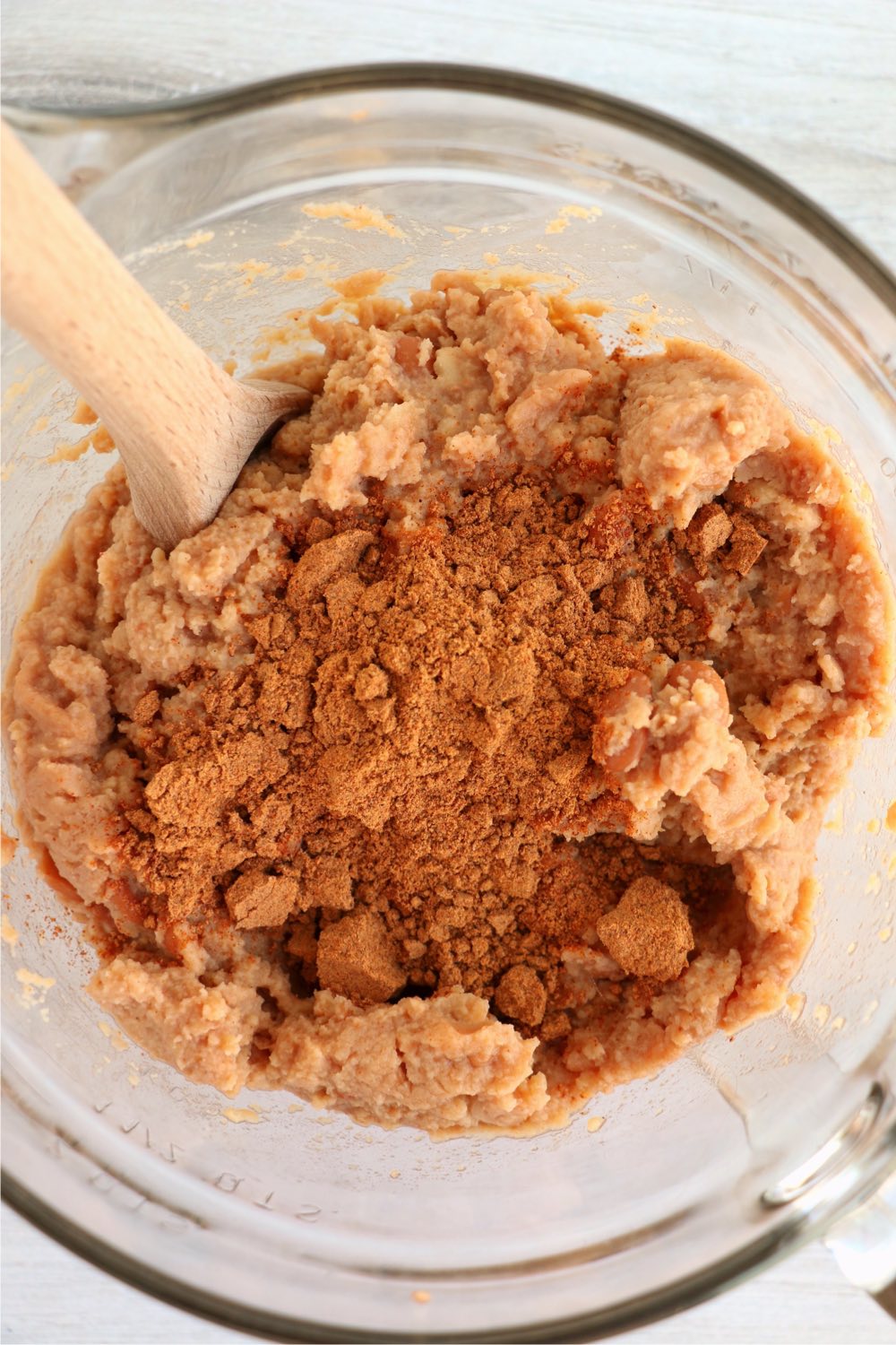 mixing together taco dip ingredients in bowl