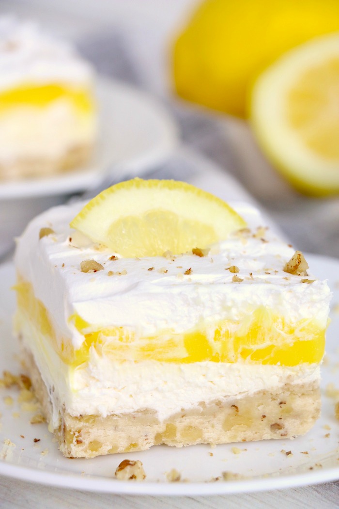 Piece of lemon lush dessert with lemon slice garnish