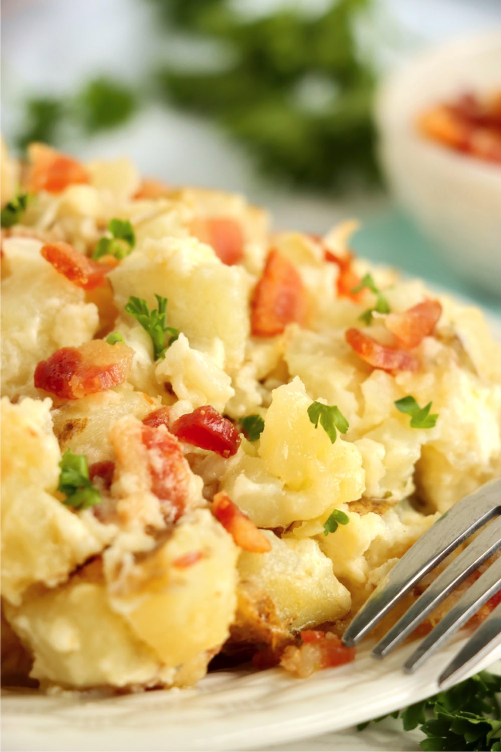 A helping of potatoes and bacon on a plate