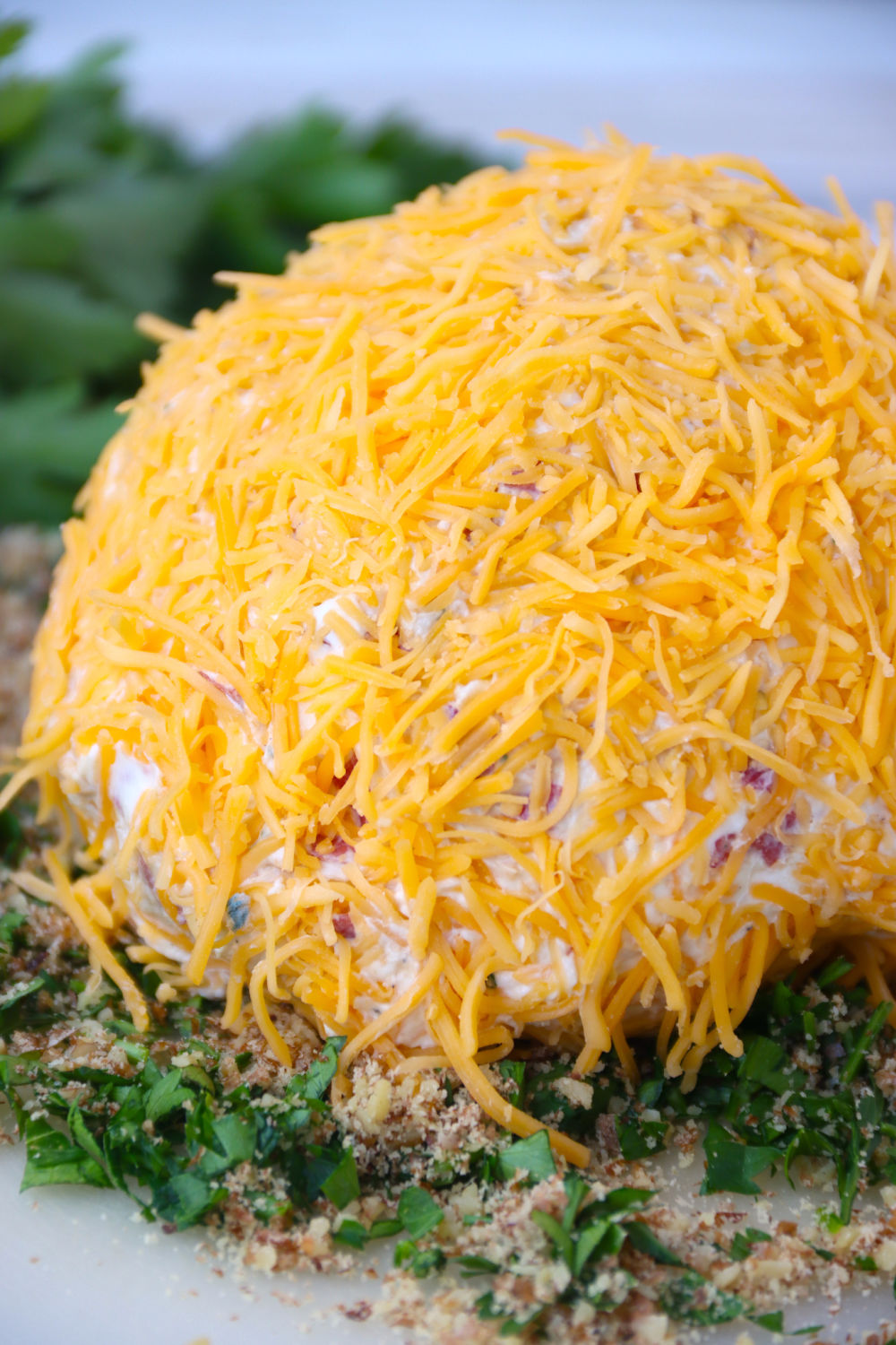 cheese ball covered in shredded cheese