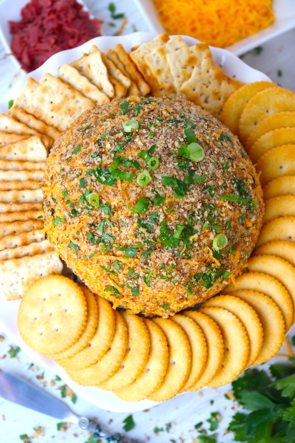 top shot of cheese ball covered with parsley and green onions
