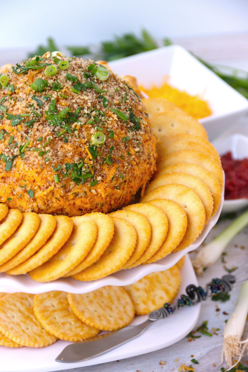 close up of cheese ball with crackers