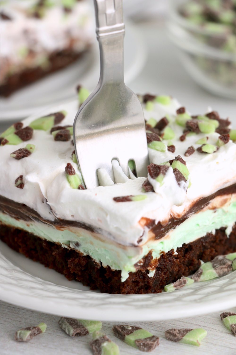 fork going into piece of lush layer dessert