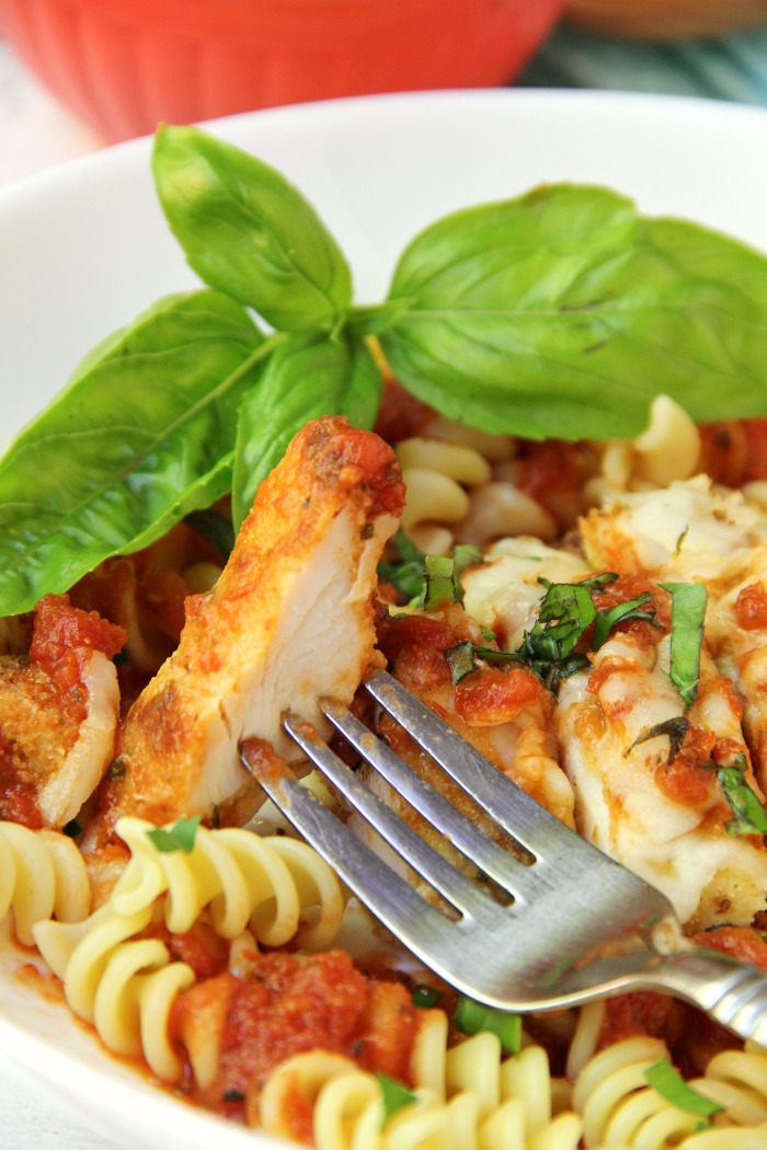 Mozzarella Basil Chicken -a delicious twist on traditional chicken parmesan. The chicken cutlets are breaded and baked, creating delicious and moist chicken to serve over pasta and sauce.