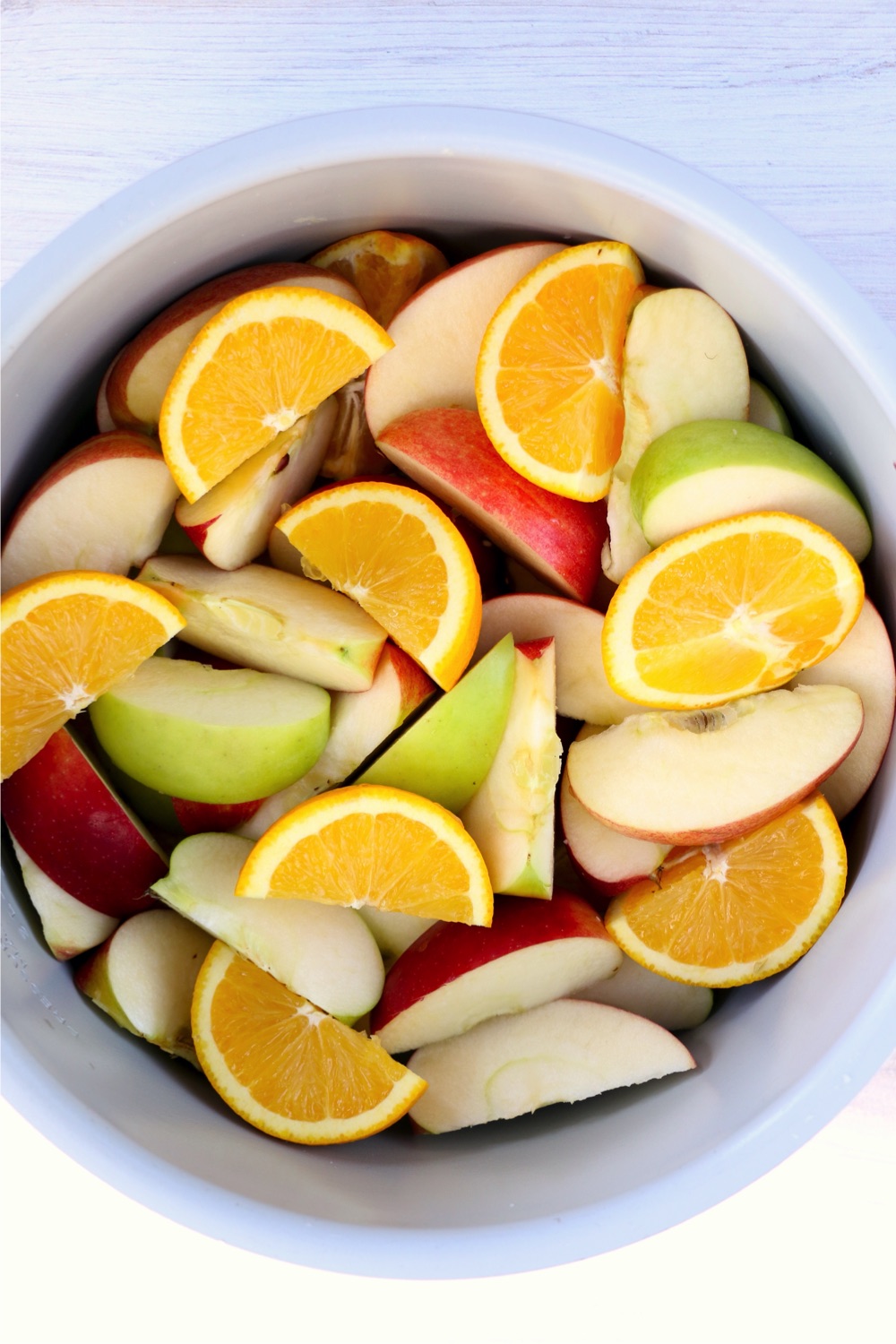 Ninja Foodi pot filled with sliced apples and oranges