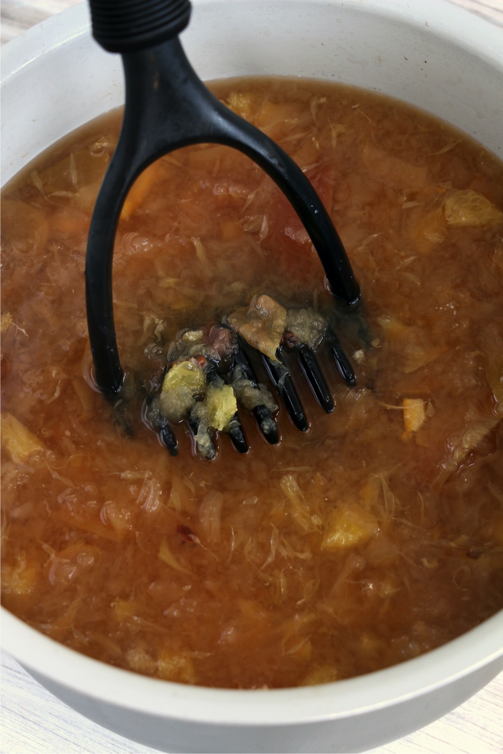 mashing fresh fruit in a Ninja Foodi cooking pot