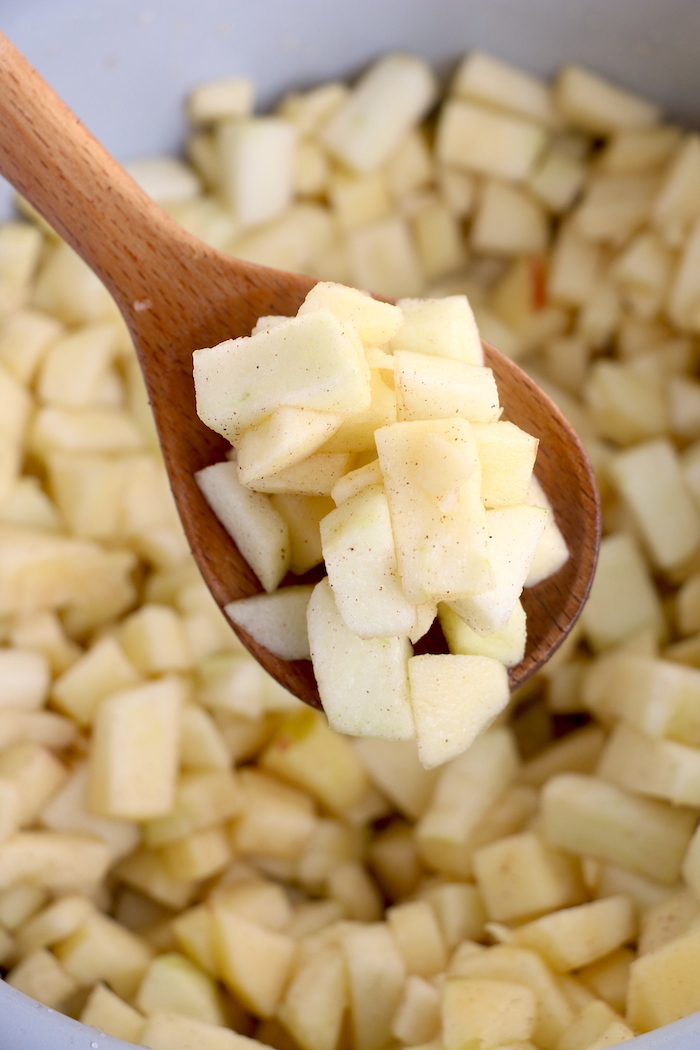 Wooden spoon of chopped up apples