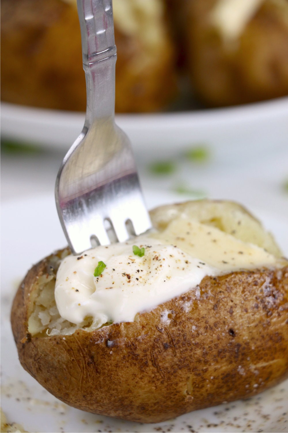 fork going into baked potato