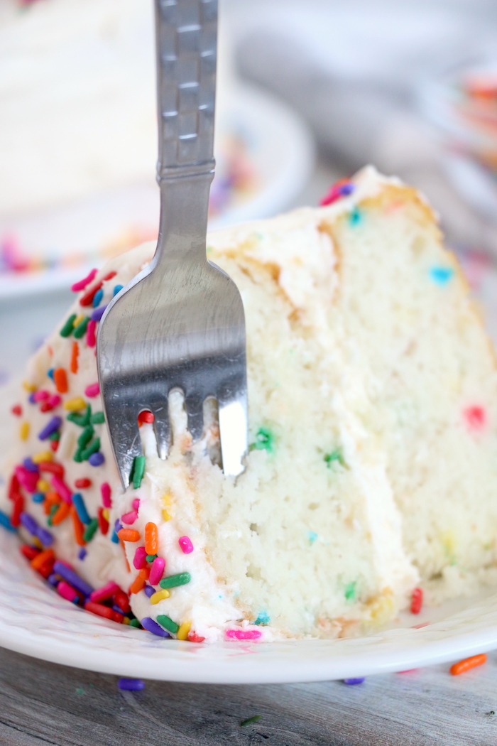 fork going into piece of confetti cake