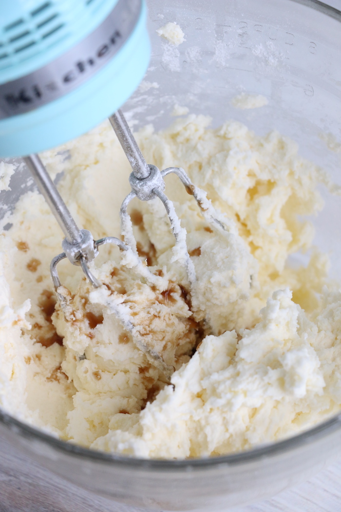 Adding vanilla extract to frosting mixture